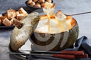 Hollowed pumpkin filled with cheese fondue
