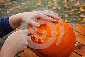 Hollowing out a pumpkin to prepare halloween lantern