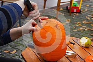 Hollowing out a pumpkin to prepare halloween lantern