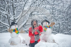 Holly jolly swag Christmas and noel. Happy woman winter portrait. Snowman. Winter portrait of young beautiful woman in