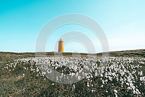 Holmsberg Lighthouse, an orange light house on the Reykjanes Peninsula in Iceland