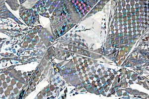 Holographic aluminium foil decor foil closeup pattern texture as background. Macro photo