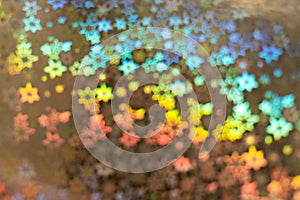 Holographic background with abstract colorful blur stars shaped bokeh