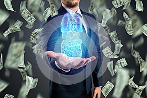 Holographic projection scan of human internal organs and dollars. The concept of the cost of modern medicine, expensive services
