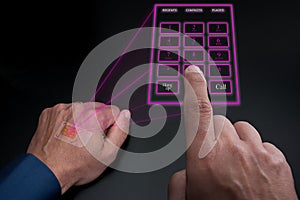 Holographic telephone keypad projected by the implanted SIM under the skin photo