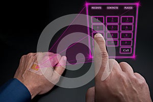 Holographic telephone keypad projected by the implanted SIM under the skin photo