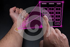 Holographic telephone keypad projected by the implanted SIM under the skin photo