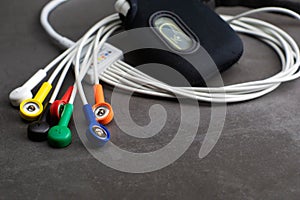 Holter, medical device for a heart rate measurement with all the colorful cables on industrial gray background photo