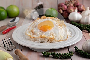 Holy Basil Fried Rice with Chicken Heart and Fried Egg on a White Wooden Floor