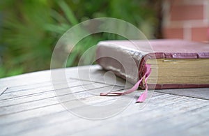 Holy Bible with brown color cover on the wood table