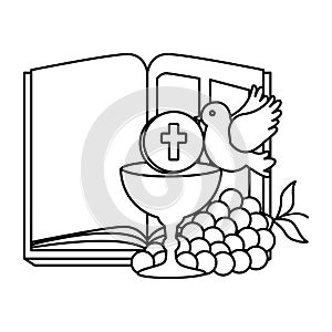 Holy bible with chalice and grapes