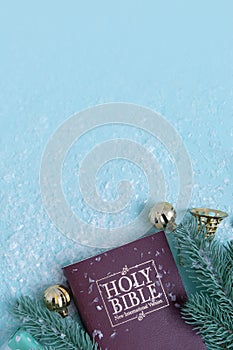 Holy bible and Christmas decor with snow. Christian winter background copy space