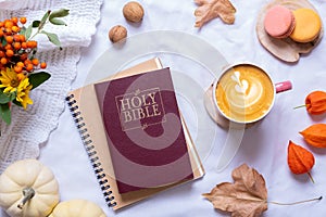 Holy Bible with cup of coffee and autumn cozy decor top view. Bible study fall concept