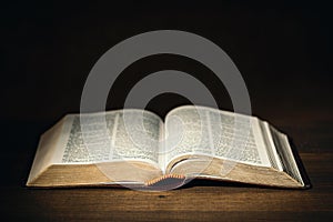 Holy Bible in the dark on a pastor desk