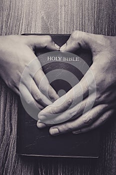 Holy Bible With Heart Shape Hands