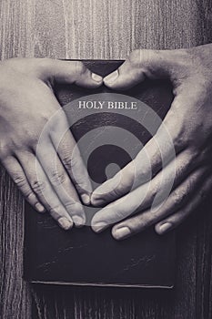 Holy Bible With Heart Shape Hands