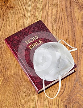 Holy Bible and N95 face Mask photo