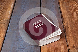 Holy Bible on old wooden church table