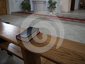 Holy Bible on old wooden church table