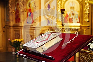 Holy Bible and Orthodox cross in orthodox church photo