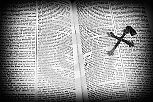 Holy Bible Page Open With A Silver Cross On Page