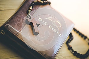 Holy bible and rosary: Christian bible and rosary on a wooden desk