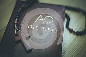 Holy bible and rosary: Christian bible and rosary on a wooden desk