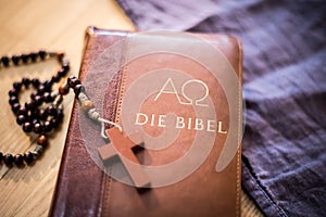 Holy bible and rosary: Christian bible and rosary on a wooden desk