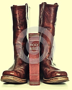 Holy bible and rugged cowboy boots photo