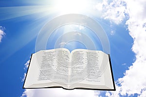 Holy bible in the sky illuminated by a sunlight
