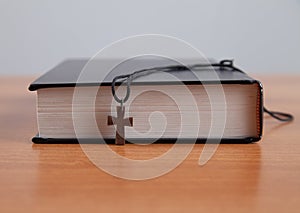 Holy Bible with a wooden cross