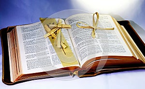 Holy Bible; Word of God with christian cross folded from palm leaf..