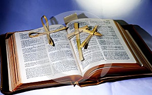 Holy Bible; Word of God with christian cross folded from palm leaf..