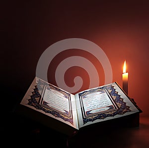 Holy book of Islam with candle light.