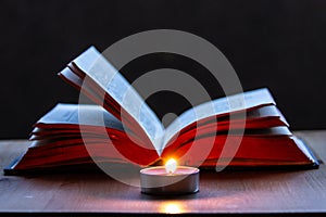 Holy Book open with candlelight