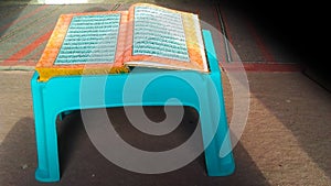 The holy book Quran on a plastic table. Islamic spirituality concept.