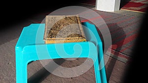 The holy book Quran on a plastic table. Islamic spirituality concept.