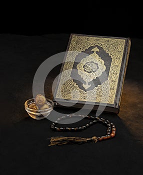 Holy Book of Quran With Rosary and Dates