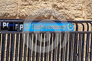 Holy Ceremony sign on police barricade