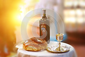 Holy communion on wooden table in church.Taking Communion.Cup of glass with red wine, bread on table.The Feast of Corpus Christi