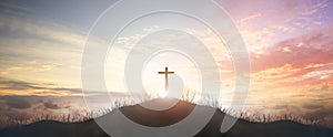 Holy concept: Silhouette cross on  mountain sunset background