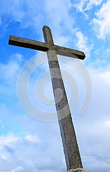 Holy Cross against Background of Blue Sky and White Clouds