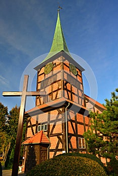 The holy cross or crucifix in front of baroque timbered church in Stegna, Pomerania region in Poland