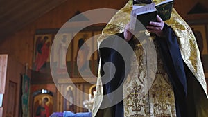 The holy father reads a prayer in the church before the ritual of baptism. Secret rite of baptism in the orthodox church