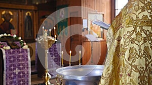 The holy father reads a prayer in the church before the ritual of baptism. Secret rite of baptism in the orthodox church