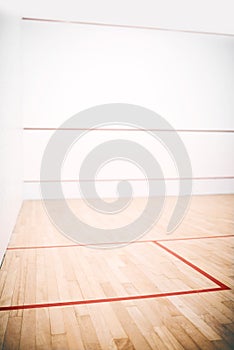 The holy frail of squash fanatics. an empty squash court.