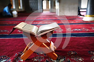 Holy Koran on stand on red carpet