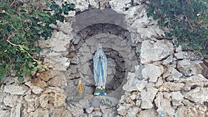 Holy Mary statue in a rock althar. Catholic Christian church religious symbol. Photographed in Croatia, Southern Europe. photo