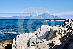 Clear waters on a Greek rocky beach photo