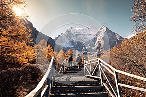 Holy mountain Xiannairi, Shangri-La view with autumn forest on sunny day at Yading nature reserve